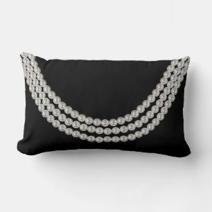string of white pearls on black lumbar pillow