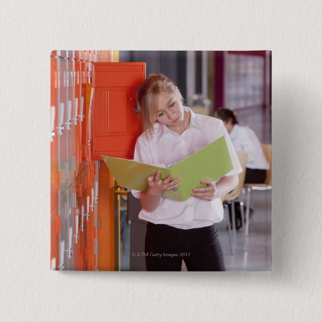 Student removing binder from school locker 2 inch square button (Front)