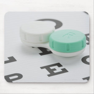 Studio shot of contact lens case on eye chart mouse pad