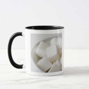Studio shot of sugar cubes in bowl mug