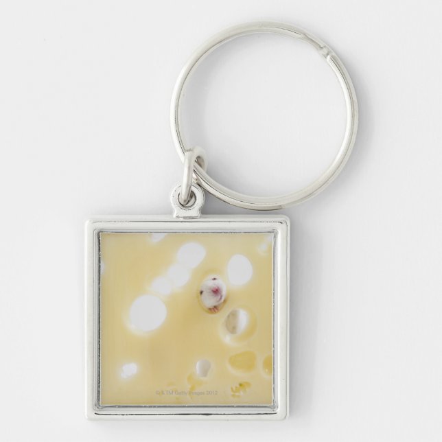 Studio shot of white mouse looking through hole keychain (Front)