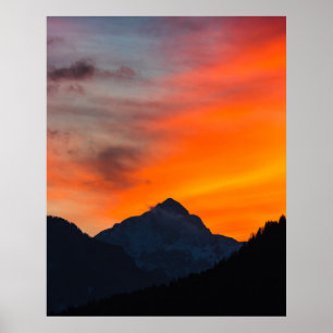Stunning vibrant sunset behind mountain poster