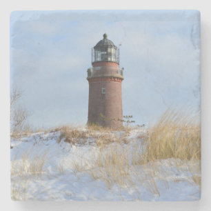 Sturdy Lighthouse on a Rocky Coast in Winter Stone Coaster