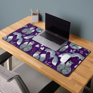 Stylized blue foxes with intricate floral designs Desk Mat