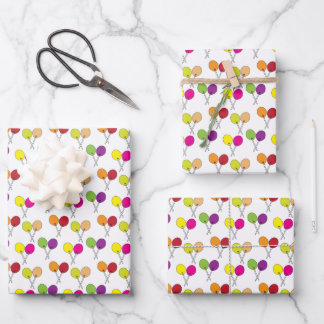 Suckers lollipops in green, purple, pink, yellow wrapping paper sheet
