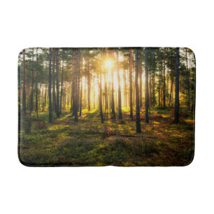 Sun beams shines in pine forest bath mat