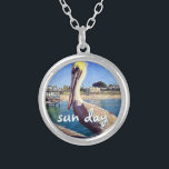 Sun Day Ocean Beach Pier Pelican Bird Photo Cute Silver Plated Necklace<br><div class="desc">“Sun day.” This cute, happy pelican perched on a railing overlooking a California beach screams “vacation ready”. Drift back to the warm ocean breezes whenever you wear this colourful photography charm necklace. This necklace comes in small, medium and large sizes, as well as both square and circle shapes. You can...</div>