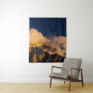 Sun lit mountains covered by clouds tapestry