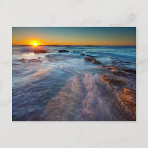 Sun rays illuminate the Pacific Ocean Postcard