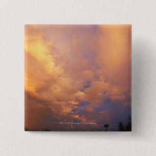Sun setting behind clouds 2 inch square button