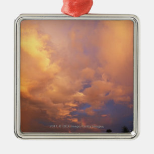 Sun setting behind clouds metal ornament