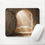 Sunbeams In an Empty Tomb Mouse Pad<br><div class="desc">An empty tomb carved from stone is illuminated by rays of light filtering through the entrance,  with a burial shroud lying on a ledge inside</div>