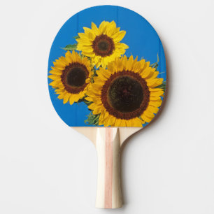 Sunflowers against blue fence ping pong paddle