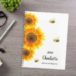 Sunflowers bees name planner<br><div class="desc">Stay organized in style with our Personalized Sunflower and Bee Spiral Planner. Featuring a delightful design of vibrant watercolored sunflowers and cheerful bees on a crisp white background, this planner adds a touch of whimsy and charm to your daily organization. Charming Sunflowers and Bees: Adorned with three large watercolored sunflowers...</div>