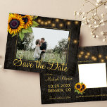 Sunflowers country barn wood save the date wedding announcement postcard<br><div class="desc">Yellow orange sunflowers and strings of twinkle lights on dark brown elegant barn wood photo save the date wedding postcard.           Easy to personalize with your names and text!            Suitable for floral summer or autumn fall / garden backyard rustic country or farmhouse themed weddings.</div>