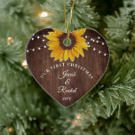 Sunflowers String Light Rustic Our First Christmas Ceramic Ornament<br><div class="desc">This personalized wedding keepsake design features a pretty painted, watercolor sunflower on a rustic wood background accented with string lights. The collection of coordinating products is available in our shop, zazzle.com/store/doodlelulu. Contact us if you need this design applied to a specific product to create your own unique matching item or...</div>