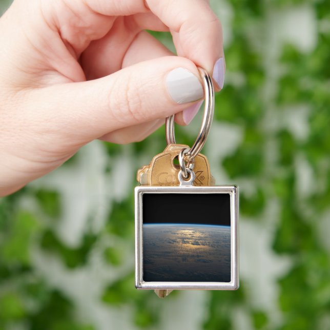Sunglint Beams Off A Partly Cloudy South Pacific Keychain (Hand)