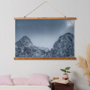 Sunlight and dark clouds over snowy mountains hanging tapestry
