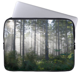 Sunlight Breaking Through a Misty Forest Laptop Sleeve