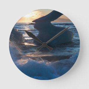 Sunrise and iceberg formation on the beach round clock