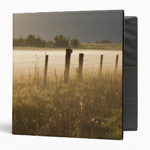 Sunrise lights fog along fence near Charlo Binder