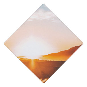 sunrise over a mountain graduation cap topper