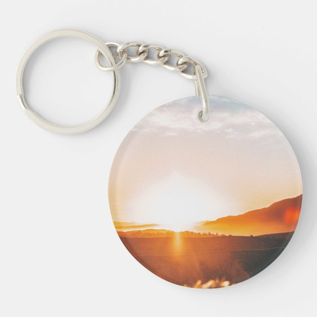 sunrise over a mountain keychain (Front)