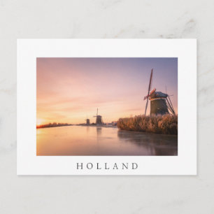 Sunrise over frozen river with windmills and reeds postcard