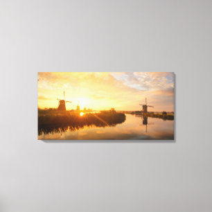 Sunrise over windmills and a river in Holland Canvas Print