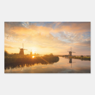 Sunrise over windmills and a river in Holland Sticker