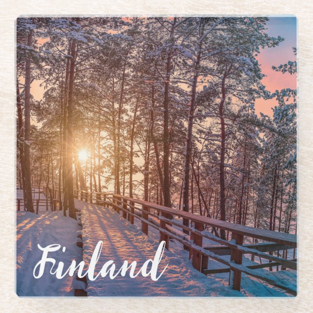 Sunset in snowy pine forest with sun ray glass coaster (Front)