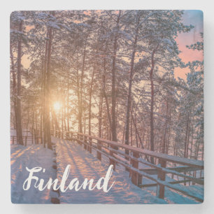 Sunset in snowy pine forest with sun ray stone coaster