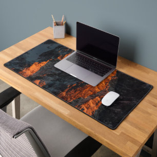 Sunset light on majestic mountains desk mat