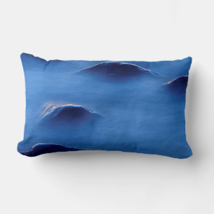 Sunset on rocks protruding through foamy water lumbar pillow