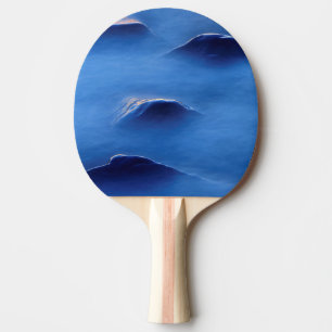 Sunset on rocks protruding through foamy water ping pong paddle