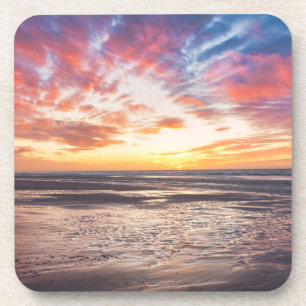 Sunset over beach and sea coaster