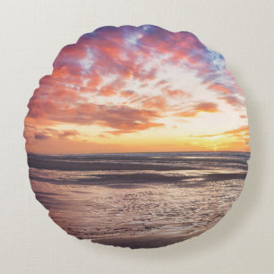 Sunset over beach and sea round pillow