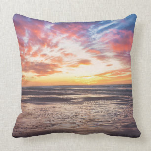 Sunset over beach and sea throw pillow