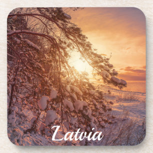 Sunset over sea and snowy pine tree coaster