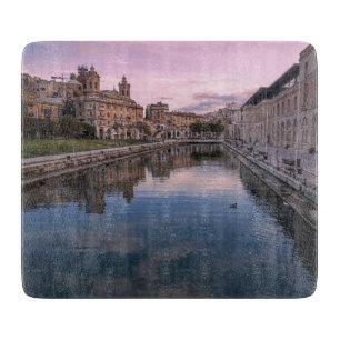 Sunset over small canal in Cospicua, Malta Cutting Board