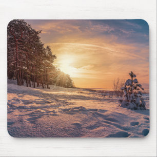 Sunset over snowy winter sea coast mouse pad