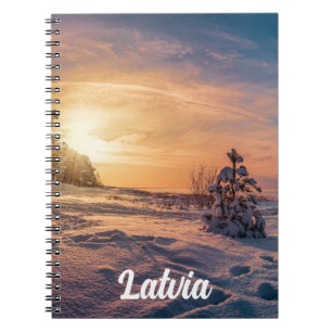 Sunset over snowy winter sea coast notebook