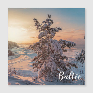 Sunset over winter snowy sea coast