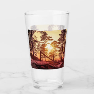 Sunset over wooden path in pine forest glass