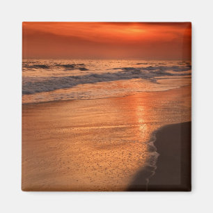 Sunset reflections off clouds and ocean shore magnet