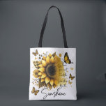 Sunshine Be the Sunshine | Tote Bag<br><div class="desc">This tote bag features a clean, modern design with a soft, uplifting aesthetic. The bag itself is white with sturdy black shoulder straps, creating a nice contrast that makes the artwork stand out. The front showcases a large, beautifully detailed sunflower in rich golden and amber tones, with layered petals and...</div>
