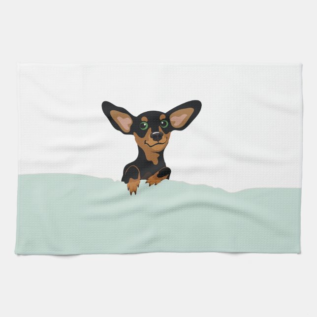 Supercute dachshund puppy under green duvet kitchen towel (Horizontal)