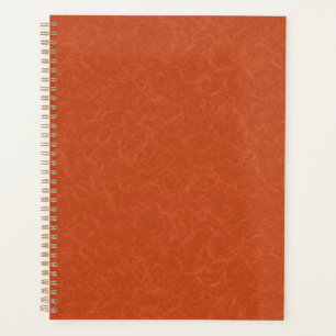 Surface orange texturée avec motif tourbillonnant