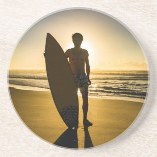 Surfer silhouette during sunrise coaster