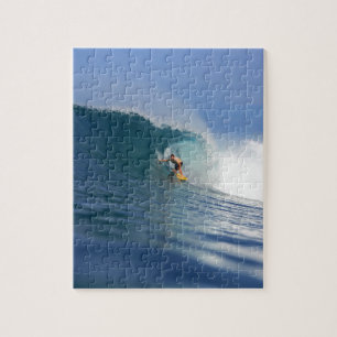Surfer surfing large blue reef wave jigsaw puzzle